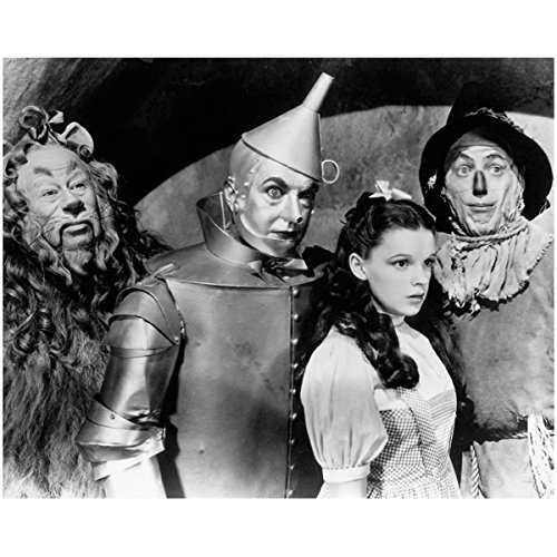 The Cowardly Lion (Bert Lahr), Tin Man (Jack Haley), Dorothy (Judy Garland), Scarecrow (Ray Bolger) all looking wide eyed