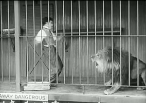 The Circus --  now that the door's unlocked, Charlie Chaplin bravely approaches the lion --  until it roars!