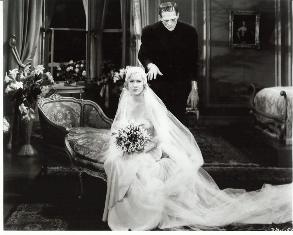 Frankenstein's monster (Boris Karloff) menacingly approaches Frankenstein's bride on their wedding night in Bride of Frankenstein