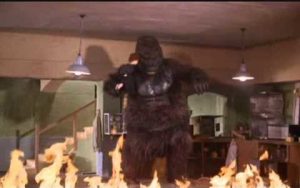 Large Konga in a laboratory fire, holding the doll that's supposed to be Margaret