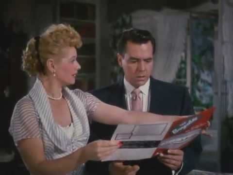 Lucy showing Desi a trailer brochure