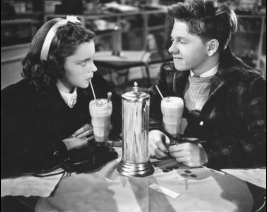 Young Judy Garland has a soda with young Mickey Rooney at the soda shop