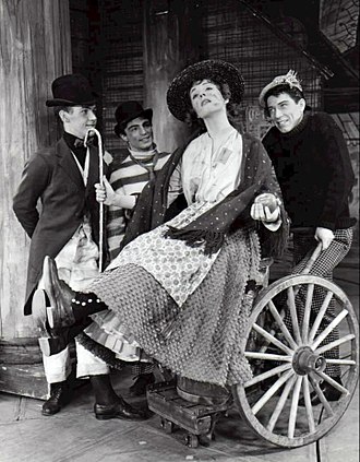 Photo of Julie Andrews and cast from My Fair Lady. In this scene, Eliza and her friends dream of a better life-"Wouldn't It Be Loverly?".