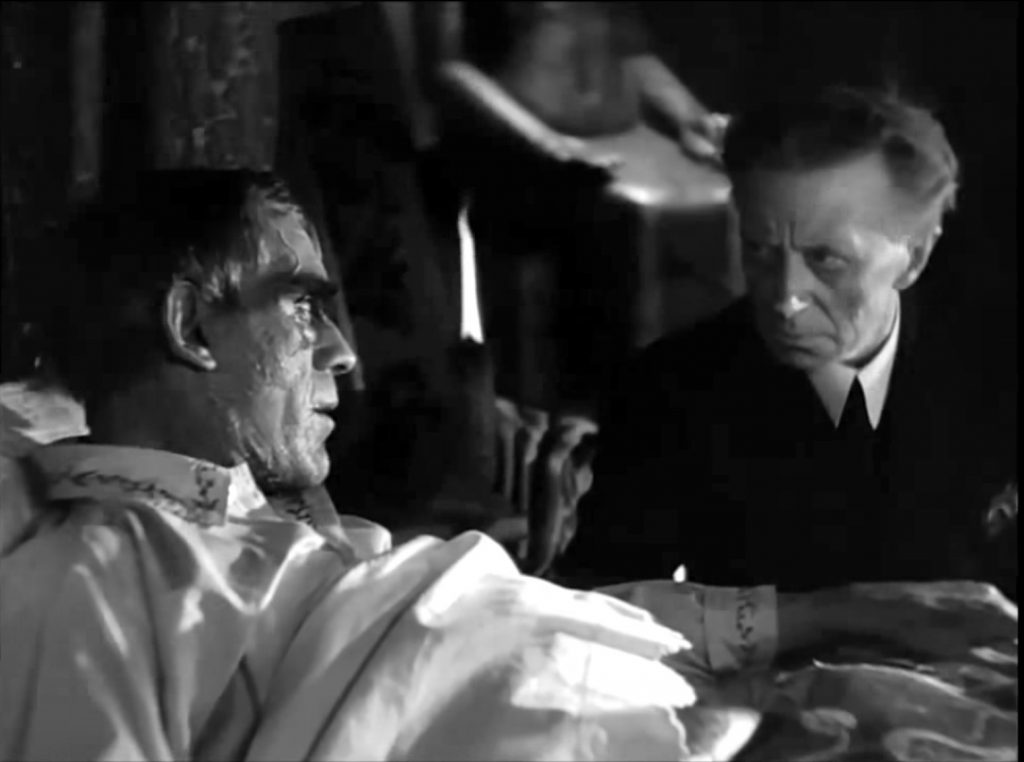 A dying Professor Morlant (Boris Karloff) gives final instructions to his butler (Ernest Thesinger) in The Ghoul