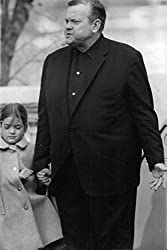 Orson Welles holding young girl's hand