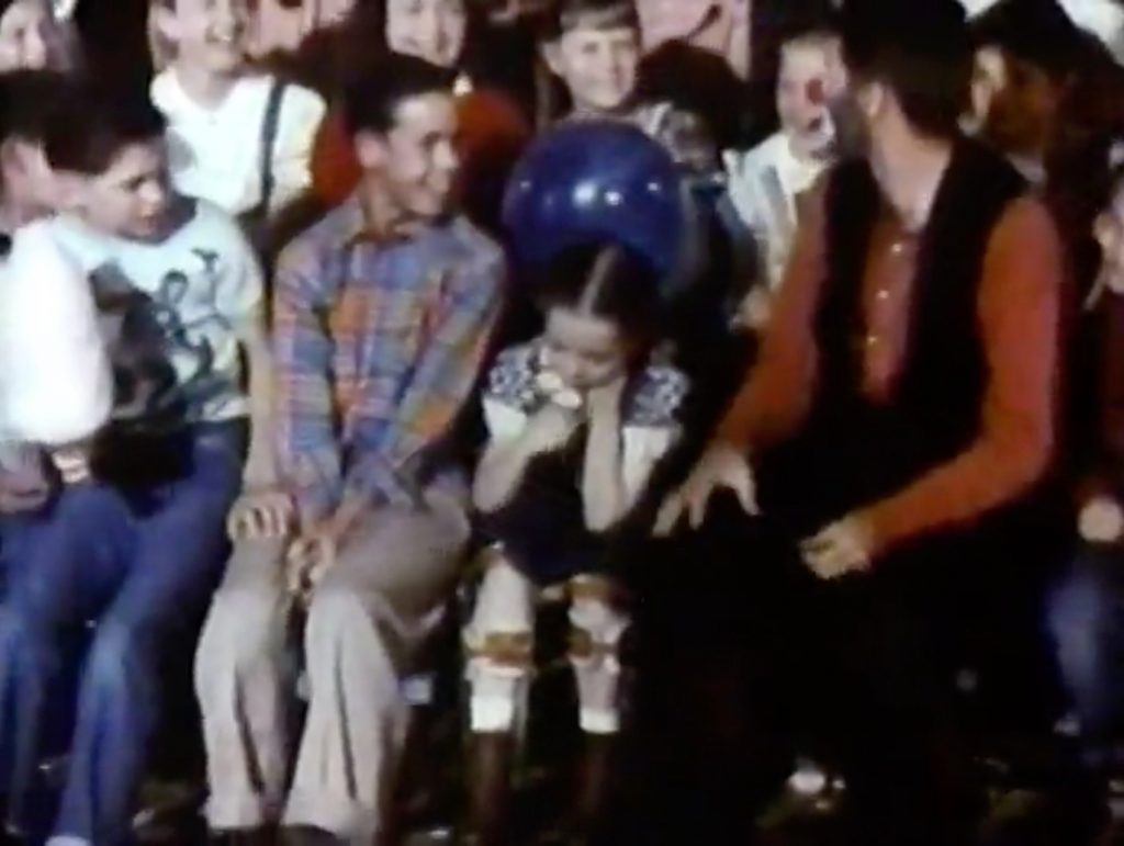Jericho (Jerry Lewis) at the orphan's benefit, desperately trying to get a crippled little girl to laugh