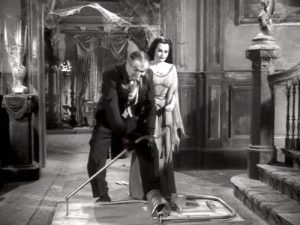 Come Back, Little Googie - Grandpa (Al Lewis) and Lily (Yvonne De Carlo) setting out a mousetrap. A BIG mousetrap