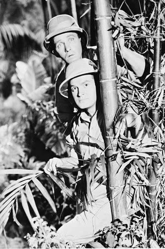 Bob Hope and Bing Crosby hiding behind a tree
