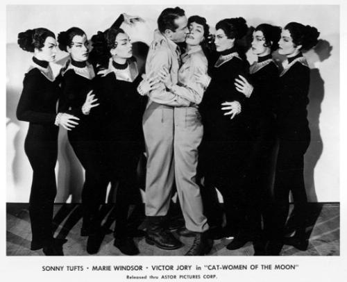 Publicity photo of Sonny Tufts kissing Marie Windsor, while the Cat-Women of the Moon look on …