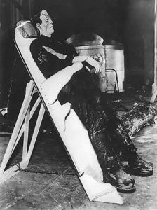 Boris Karloff as the creature, strapped to a table, in Frankenstein 1931