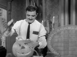 Gomez carves the Halloween pumpkin - with Uncle Fester as his model!