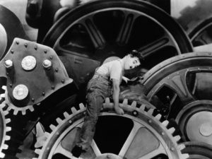Charlie Chaplin riding the gears in "Modern Times"