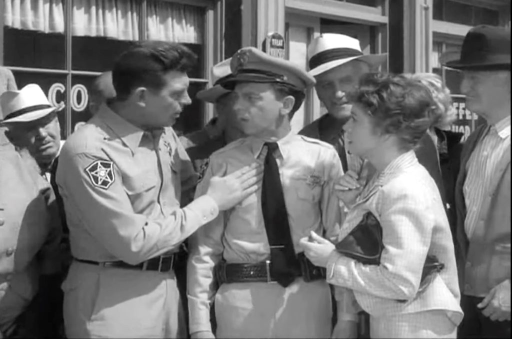 Sheriff Andy Taylor tells Thelma Lou (and everyone else) that Barney's a hero in "Barney Gets His Man"