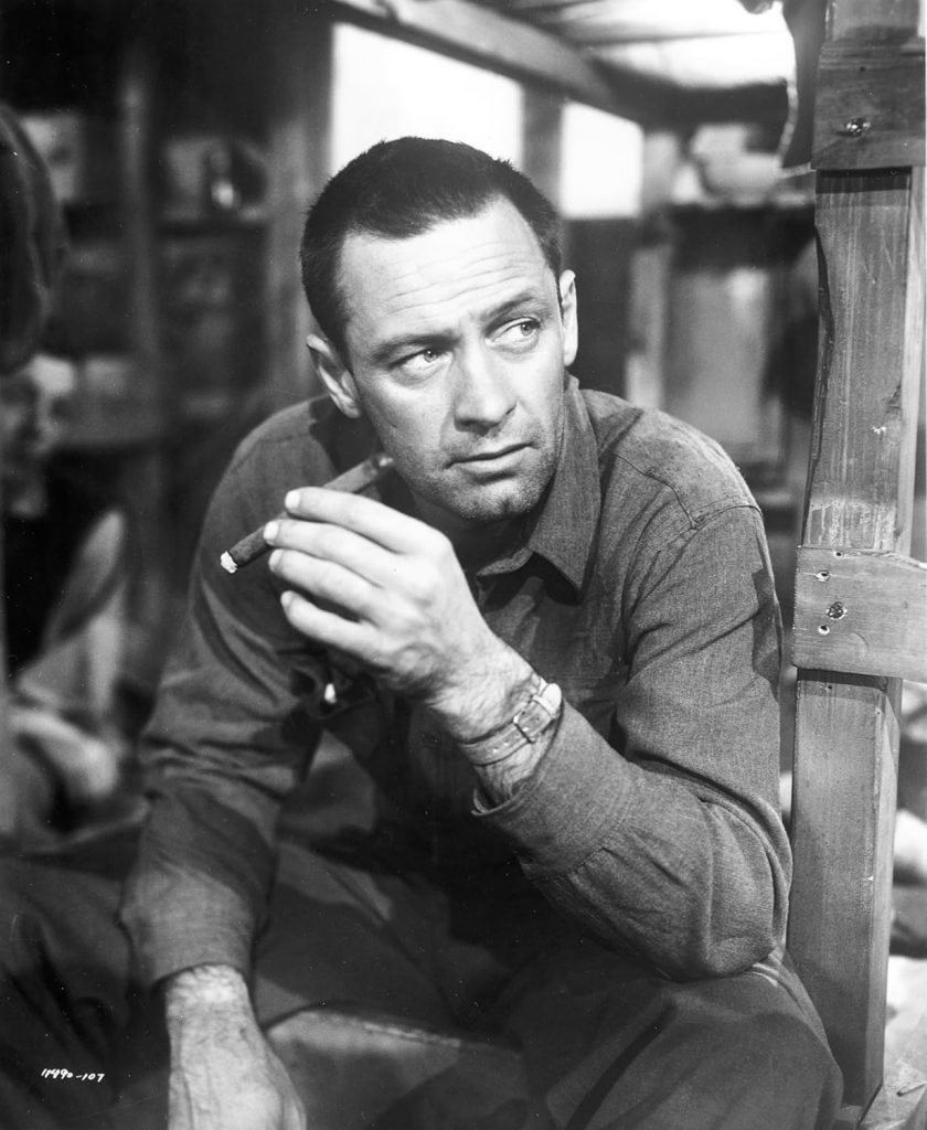 William Holden as J. J. Sefton, the central character in Stalag 17