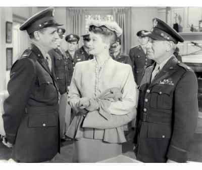 Lucille Ball flanked by military officers in "Best Foot Forward"