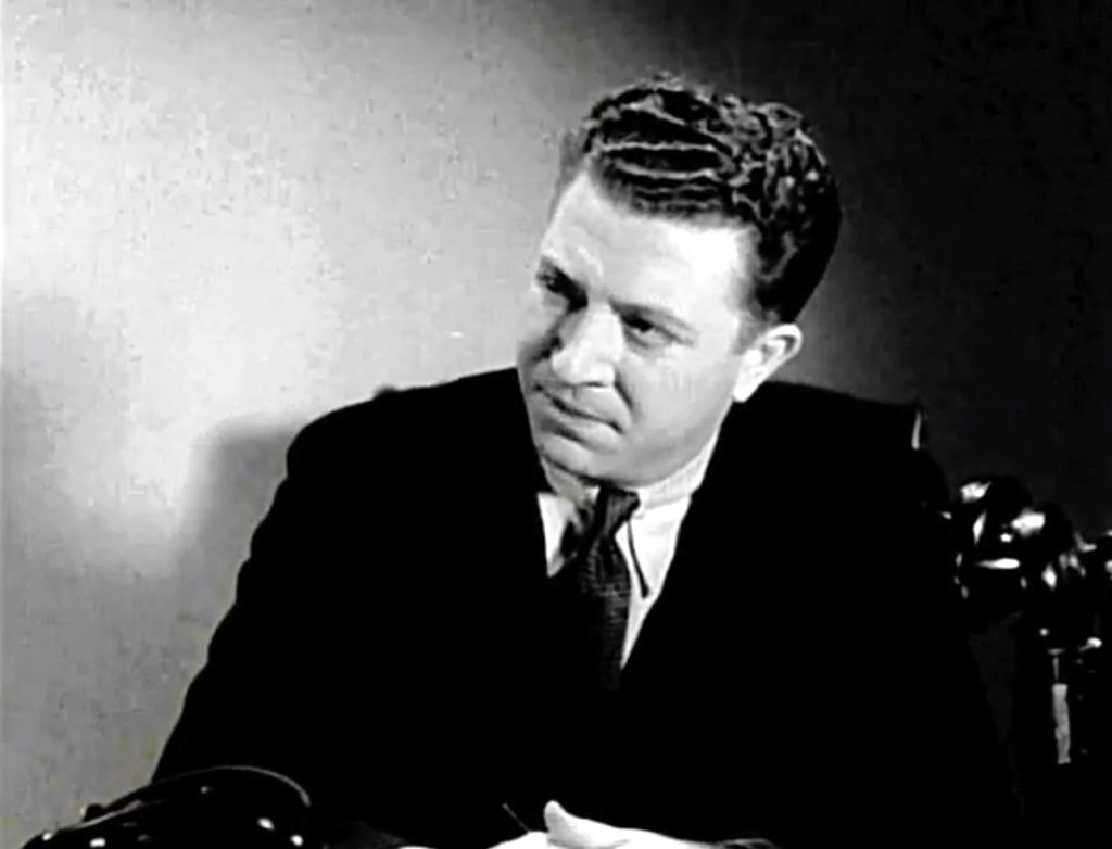 Frank McHugh as Jim, Charlotte's editor in "Mystery of the Wax Museum"