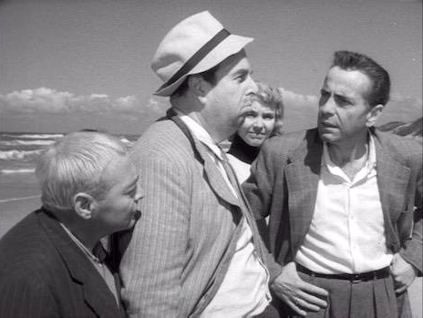 Hustlers and con men in "Beat the Devil" - Peter Lorre, Robert Morley, Humphrey Bogart with Jennifer Jones in the background