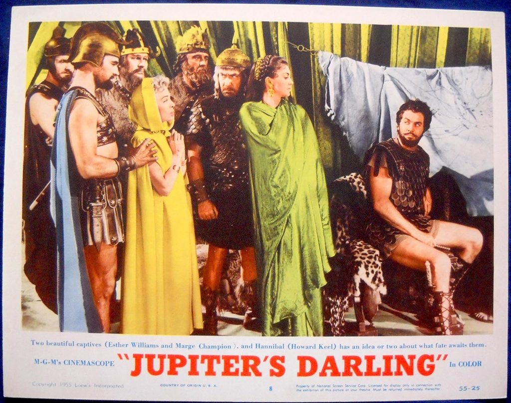 Two beautiful captives (Marge Champion and Esther Williams) await Howard Keel to decide their fate in "Jupiter's Darling"
