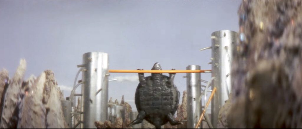 The infamous, ridiculously cheesy scene of Gamera launching himself off parallel bars against Guiron! The most memorable scene in Attack of the Monsters, frankly.